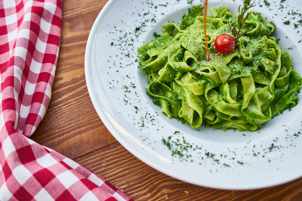 image of a protein packed vegan variation of a classic basil pesto recipe, the extra spirulina and nutritional yeast complements the nuttiness of pignoli. 
